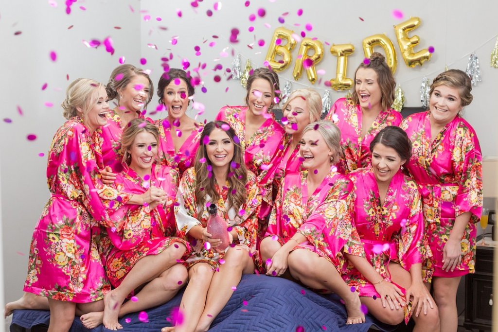 Bride and bridesmaids with confetti