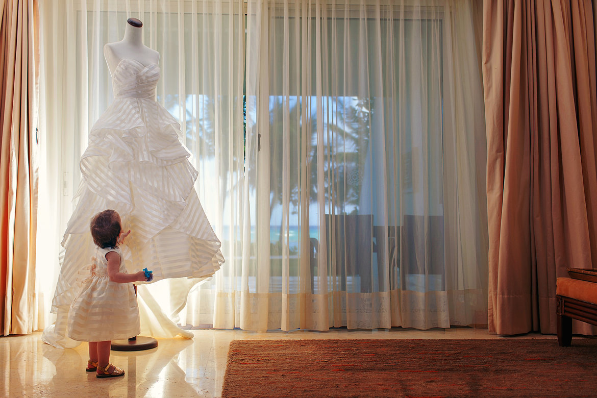 flower girl admiring wedding dress