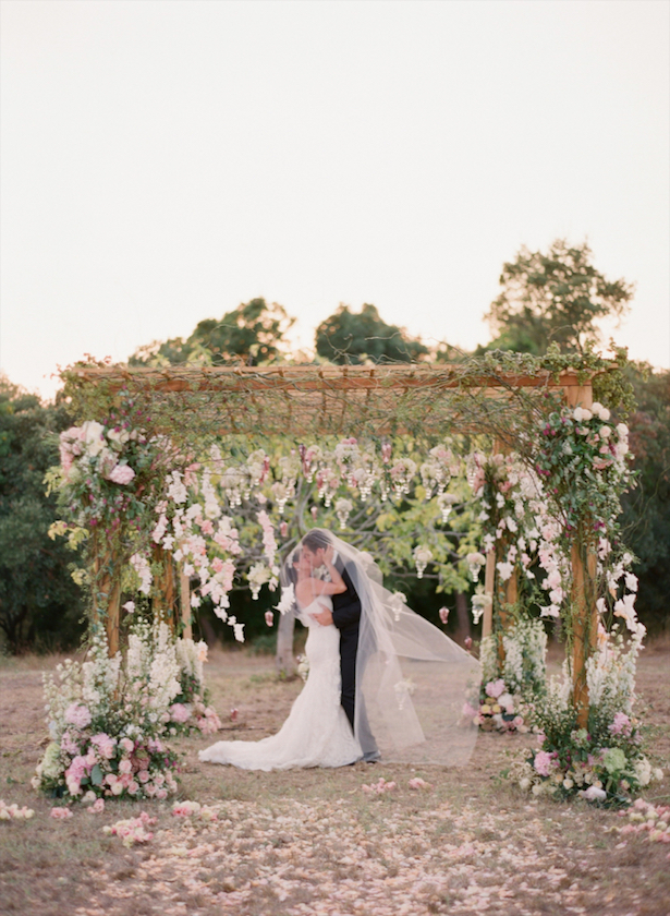 bride and groom under veil