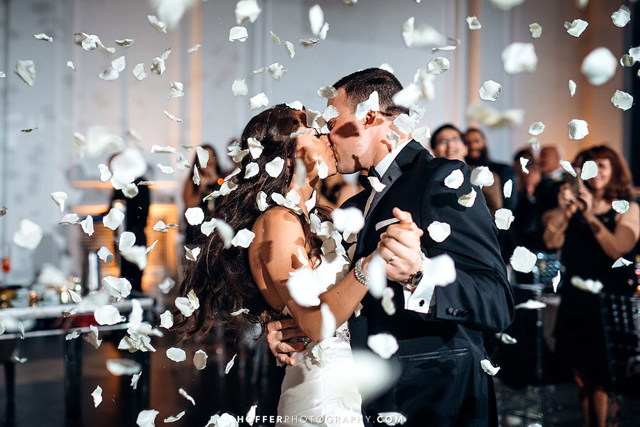 couple dancing under flower petal toss