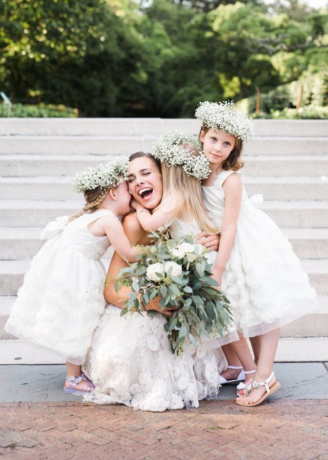 bride hug flower girls