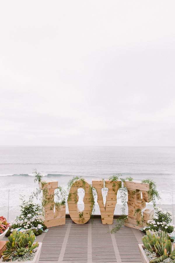 ocean wedding ceremony backdrop with diy wooden love letters