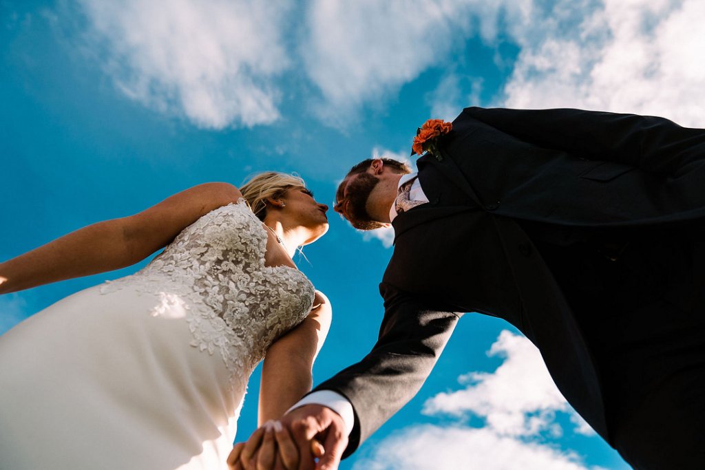 low angle wedding kiss photo