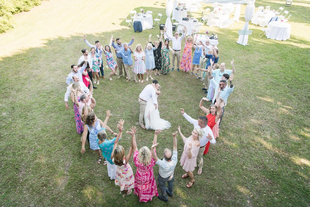 wedding guests in a heart shape around the couple