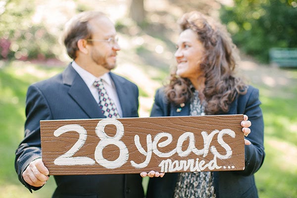 bride holding parents wedding photo