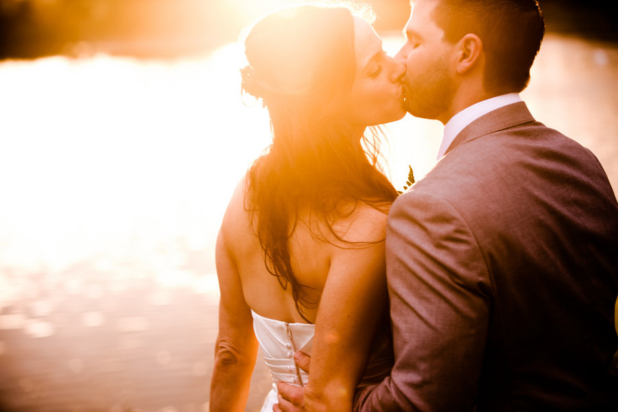 bride and groom sunset kiss