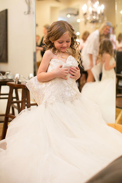 flower girl in brides wedding dress