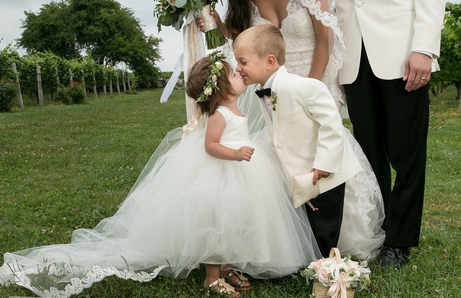 flower girl and ring bearer kissing