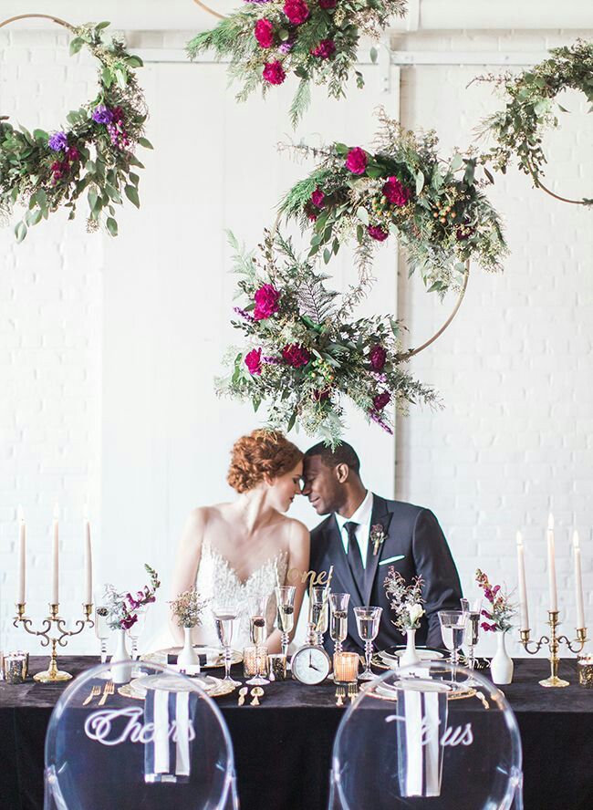 couple with flower wreaths