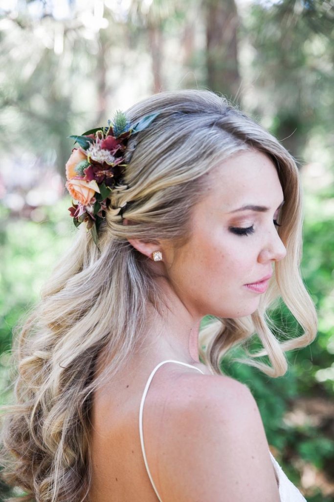 loose curls with a fresh flower clip