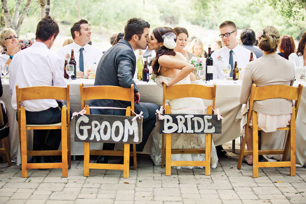 bride and groom kissing at a backyard wedding