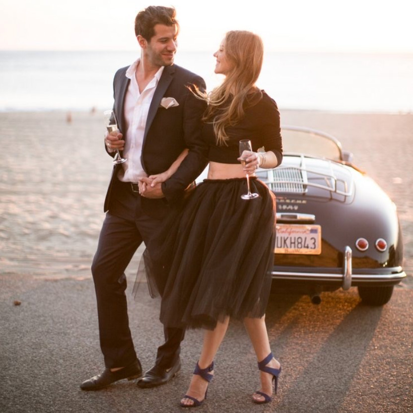 engaged couple walking on the beach