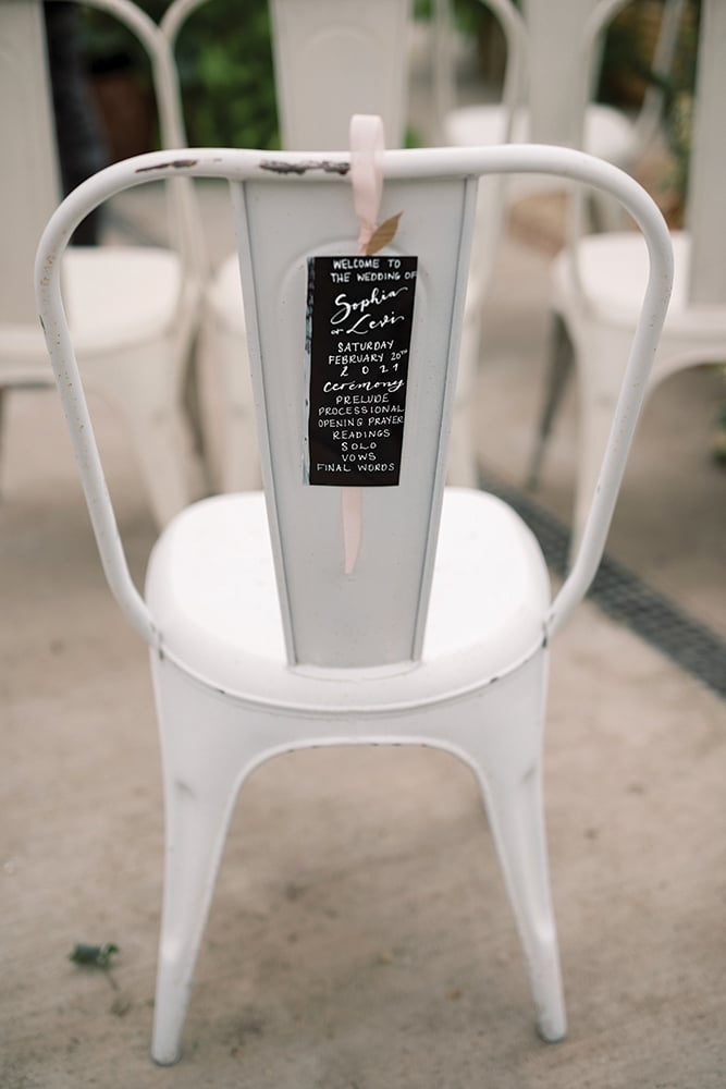 Wedding ceremony programs on chair backs