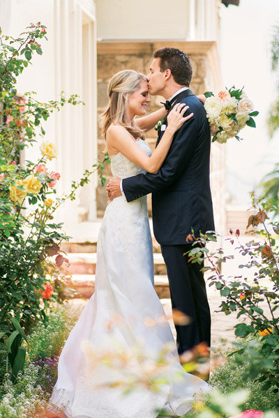 bride and groom kiss on forehead