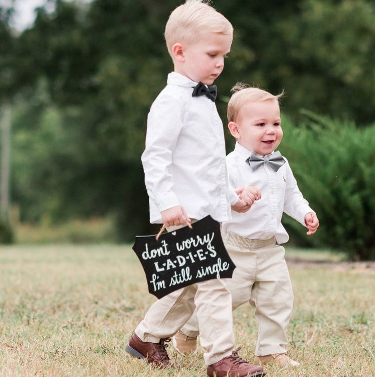 ring bearers with a cute sign