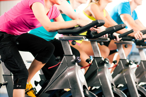 women on exercise bikes