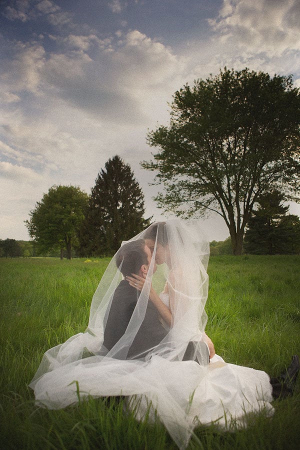 bride and groom under the brides veil