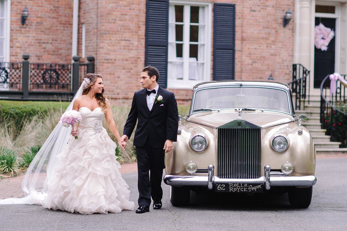 bride and groom at limo