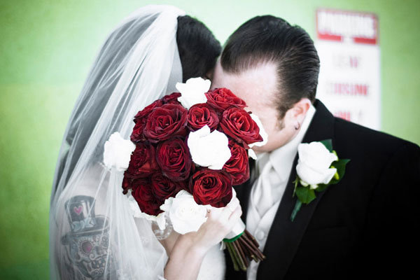 bride and groom covering their faces