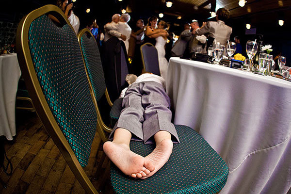 kid sleeping across chairs