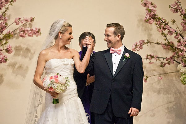 bride and groom hold hands