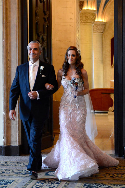 father and bride walking down the aisle