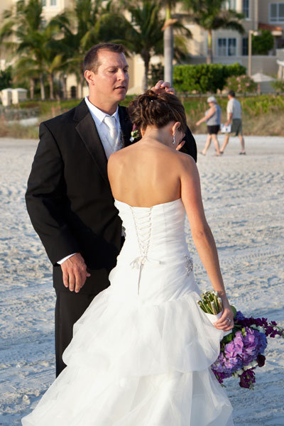 groom fixing brides hair 